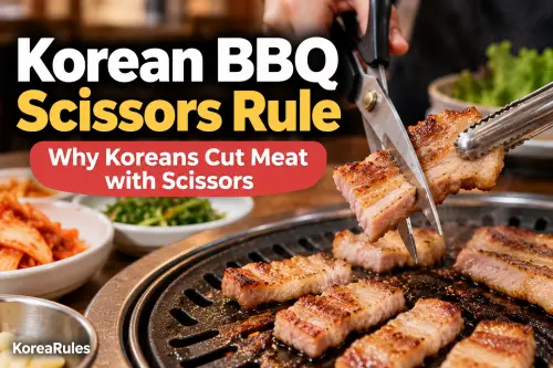 Korean BBQ meat being cut with kitchen scissors and tongs over a tabletop grill.